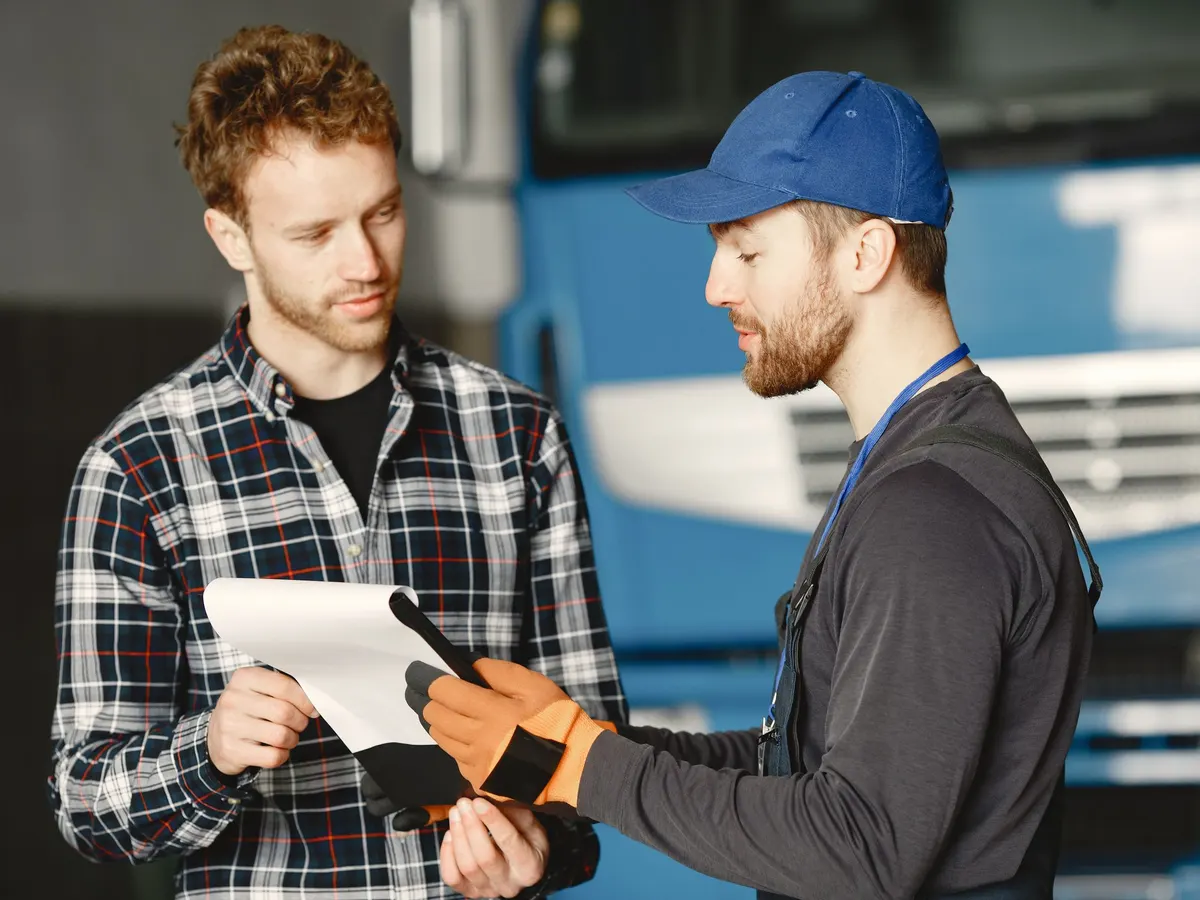 A service advisor talking a customer through the work done on his vehicle